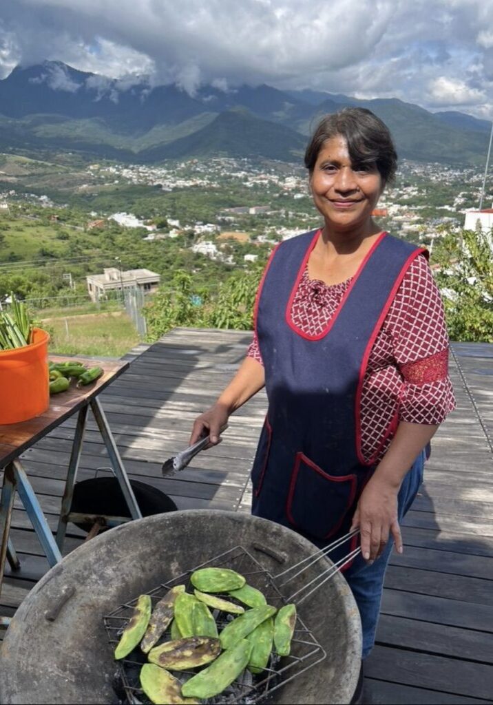 Berta, an expert cook in local cuisine, grills nopales.